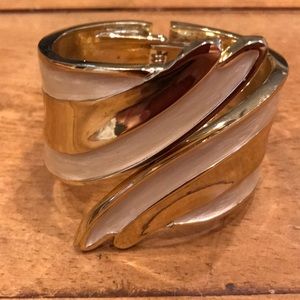 Elegant gold-tone and beige cuff.
